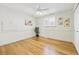 Bright bedroom with hardwood floors, ceiling fan, and shuttered window at 7867 S Poplar Way, Centennial, CO 80112