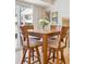 Cozy dining area features a square wood table with four chairs and sliding door access at 7867 S Poplar Way, Centennial, CO 80112