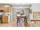 Bright dining area adjacent to the kitchen boasts a modern light fixture and access to backyard at 7867 S Poplar Way, Centennial, CO 80112