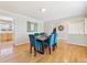 Elegant dining room with hardwood floors, stylish furnishings, and abundant natural light from the large window at 7867 S Poplar Way, Centennial, CO 80112