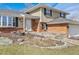 Charming home exterior with brick accents, large windows, and a well-kept lawn at 7867 S Poplar Way, Centennial, CO 80112