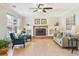 Inviting living room features a brick fireplace, built-in shelves, and large windows at 7867 S Poplar Way, Centennial, CO 80112