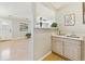 Charming serving area with sink, cabinets, and connection to the living room and front entryway at 7867 S Poplar Way, Centennial, CO 80112