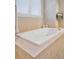 A luxurious bathroom with a large soaking tub and tile surround at 22419 Springflower Dr, Golden, CO 80401