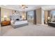 A spacious main bedroom featuring a king-size bed, large windows, and neutral decor at 22419 Springflower Dr, Golden, CO 80401