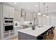 Modern kitchen with stainless steel appliances, an island with seating, and pendant lighting at 22419 Springflower Dr, Golden, CO 80401