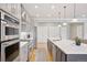 Open kitchen features stainless steel appliances, an island, and hardwood floors at 22419 Springflower Dr, Golden, CO 80401