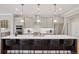 Spacious kitchen island offers barstool seating beneath modern pendant lighting at 22419 Springflower Dr, Golden, CO 80401