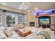 This living room has a fireplace, built in entertainment system, a projector, and sliding doors to a patio at 22419 Springflower Dr, Golden, CO 80401