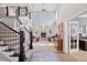 Open-concept living room with high ceilings, a fireplace, and staircase to a second level at 22419 Springflower Dr, Golden, CO 80401