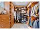 A large walk-in closet with custom wood shelving and drawers at 22419 Springflower Dr, Golden, CO 80401