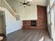 Open living room with brick fireplace and hardwood floors at 17548 E Wesley Pl, Aurora, CO 80013