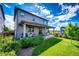 Expansive backyard featuring a covered patio, lush green lawn, and mature landscaping at 350 Vista Cliff Cir, Castle Rock, CO 80104