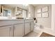 Bright bathroom featuring a gray vanity with white countertop and hexagonal tile flooring at 350 Vista Cliff Cir, Castle Rock, CO 80104