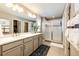 Bright bathroom with double vanity, quartz countertops, and glass-enclosed shower, with neutral colors at 350 Vista Cliff Cir, Castle Rock, CO 80104