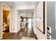 Inviting hallway view leading into a bright, open-concept kitchen and living space with hardwood floors at 350 Vista Cliff Cir, Castle Rock, CO 80104