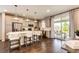 Open kitchen with island seating, stainless appliances, and sliding glass door to the patio at 350 Vista Cliff Cir, Castle Rock, CO 80104