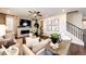Comfortable living room with fireplace, neutral decor, and stairs to the second floor at 350 Vista Cliff Cir, Castle Rock, CO 80104