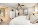 Spacious bedroom with plush carpet, ensuite bathroom, ceiling fan, and walk in closet at 350 Vista Cliff Cir, Castle Rock, CO 80104
