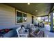 Relaxing covered patio with a barbecue grill, comfortable seating, and a dining set nearby at 350 Vista Cliff Cir, Castle Rock, CO 80104