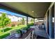 Covered patio with outdoor seating area and dining table overlooking a well-maintained backyard at 350 Vista Cliff Cir, Castle Rock, CO 80104
