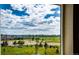 Scenic view from a window overlooking green fields, and houses, providing natural sunlight at 350 Vista Cliff Cir, Castle Rock, CO 80104