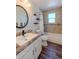 Bathroom featuring a granite counter-top sink, decorative wall tiles and dark wood floor at 1109 E 7Th Avenue Cir, Broomfield, CO 80020