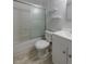 This bathroom features a shower over tub, storage shelves, a white sink, and modern light wood floors at 1109 E 7Th Avenue Cir, Broomfield, CO 80020