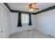 Bedroom with neutral carpet, a ceiling fan, wallpaper border, and a large window at 1109 E 7Th Avenue Cir, Broomfield, CO 80020