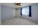 Bright bedroom featuring neutral decor, a ceiling fan, and a window for natural light at 1109 E 7Th Avenue Cir, Broomfield, CO 80020