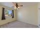 Bright bedroom featuring neutral carpet, a ceiling fan, and a large window with outside view at 1109 E 7Th Avenue Cir, Broomfield, CO 80020