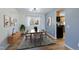 Staged dining room with hardwood floors and a window overlooking the outdoors, with access to the kitchen at 1109 E 7Th Avenue Cir, Broomfield, CO 80020