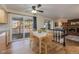 Eat-in dining area featuring wood floors, a ceiling fan, and access to the outdoor deck at 1109 E 7Th Avenue Cir, Broomfield, CO 80020