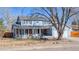 Charming two-story home featuring a welcoming front porch, a well-maintained lawn, and mature trees at 1109 E 7Th Avenue Cir, Broomfield, CO 80020