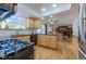 Bright kitchen featuring wood cabinets, stainless steel appliances, hardwood floors, and black countertops at 1109 E 7Th Avenue Cir, Broomfield, CO 80020