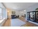 Staged living room with hardwood floors, a large window, and cozy seating creating an inviting atmosphere at 1109 E 7Th Avenue Cir, Broomfield, CO 80020