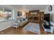 Cozy living room featuring a brick fireplace, built-in shelves, and comfortable seating at 1109 E 7Th Avenue Cir, Broomfield, CO 80020