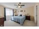 Serene main bedroom with a ceiling fan, plush carpet, and a large window that floods the room with light at 1109 E 7Th Avenue Cir, Broomfield, CO 80020