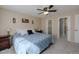 Comfortable main bedroom with soft carpet, a ceiling fan, and a view into the ensuite bathroom at 1109 E 7Th Avenue Cir, Broomfield, CO 80020