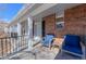 Inviting porch featuring brick accents, seating, and a welcoming entrance to the home's front door at 1109 E 7Th Avenue Cir, Broomfield, CO 80020