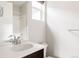 Bright bathroom showcasing a sleek vanity with dark wood cabinets, a modern faucet, and a shower with a glass door at 6068 Beeler Ct, Denver, CO 80238