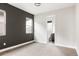 Bedroom featuring a gray accent wall, carpet flooring, bright white walls, and a view into the bathroom at 6068 Beeler Ct, Denver, CO 80238