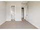 Clean bedroom featuring neutral walls, carpet floors, and entrances to a walk-in closet and bathroom at 6068 Beeler Ct, Denver, CO 80238