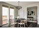 Elegant dining room with a modern chandelier, large round table, and access to a study at 6068 Beeler Ct, Denver, CO 80238