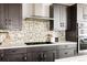 Well-equipped kitchen boasting dark cabinets, stainless appliances, and a decorative backsplash at 6068 Beeler Ct, Denver, CO 80238