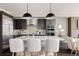 Beautiful kitchen featuring a large center island, modern pendant lighting, and stainless steel appliances at 6068 Beeler Ct, Denver, CO 80238