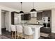 Modern kitchen with a center island, stainless steel refrigerator, and stylish cabinetry at 6068 Beeler Ct, Denver, CO 80238