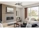 Elegant living area with a sleek fireplace, comfortable seating, and large windows at 6068 Beeler Ct, Denver, CO 80238