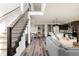 Bright and airy living room showcasing an open-concept design to the dining and kitchen areas at 6068 Beeler Ct, Denver, CO 80238