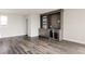 Living room featuring hardwood floors and a built-in bar with a mini-fridge and shelving at 6068 Beeler Ct, Denver, CO 80238